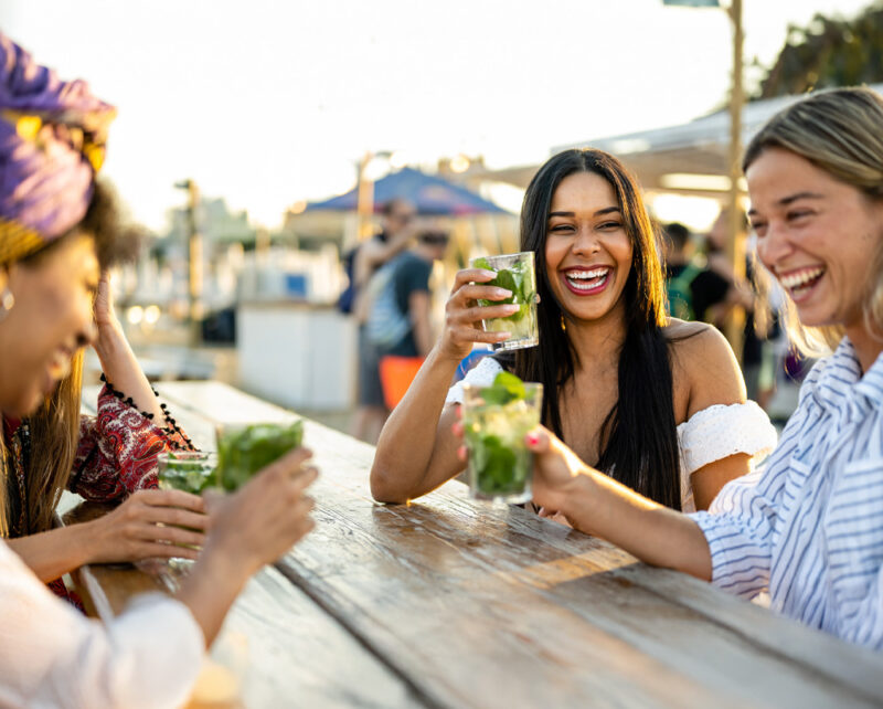 Friends sitting at a picnic table having fun