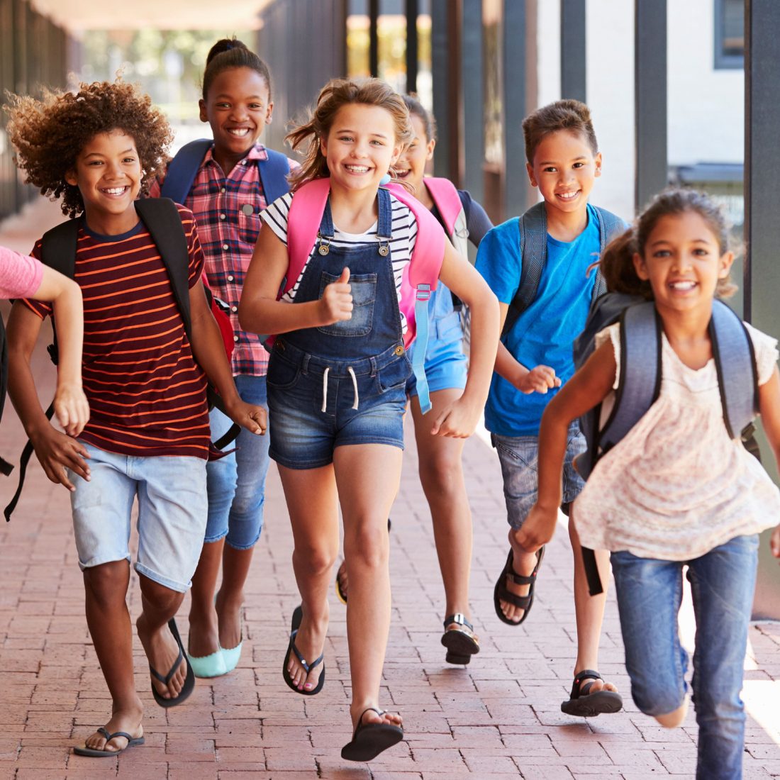 children running outside at school
